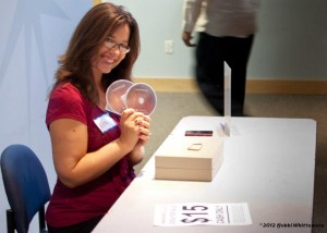 Lisa Sullivan (@lisasullivan) holds up DVDs of Abandoned Allies at the premiere at IMAX at Marbles in 2012.
