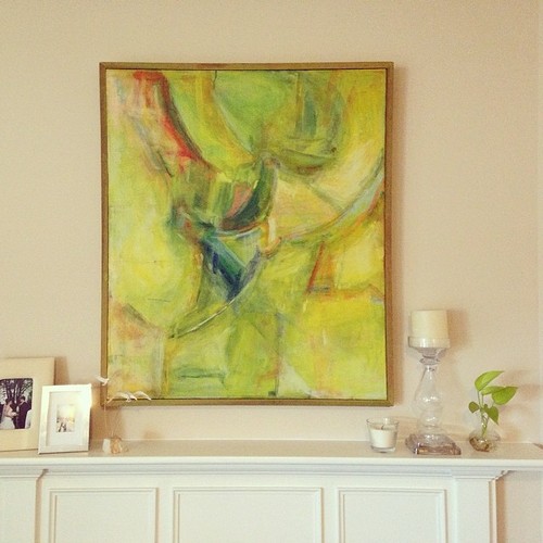 The pretty mantle in the living room with artwork by my mom and photos from our engagement and wedding.
