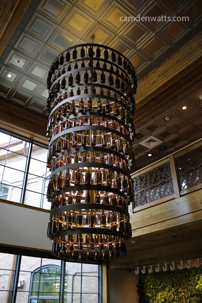 Beer bottle chandelier, as seen from the bottom of the steps